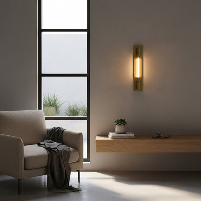 Verve matte black lamp above a freestanding bathtub with candles and stone wall