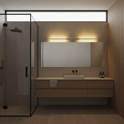 Elan wall lamp glowing softly in a modern bedroom at night with clean lines