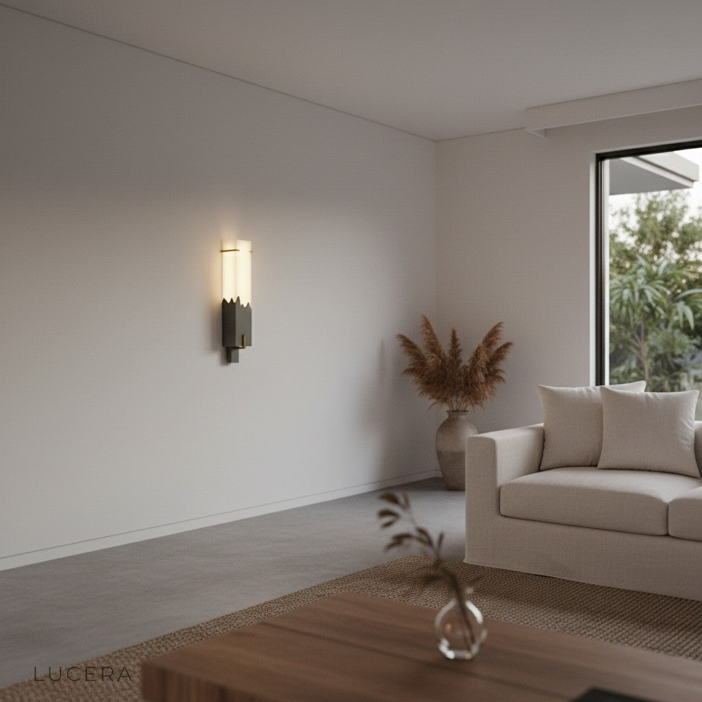 Studio shot of Axonal wall lamp angled right showing compact silhouette and warm bulb