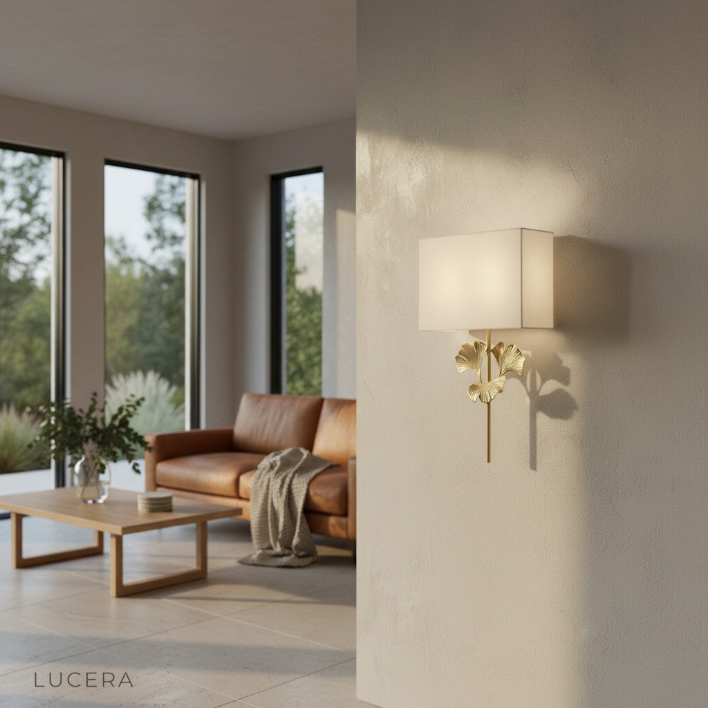 elegant brass wall sconce casting leaf shadow in reading nook