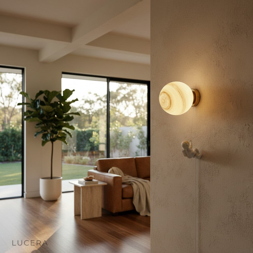 side angle of the sconce showing the resin planet silhouette and metal arm