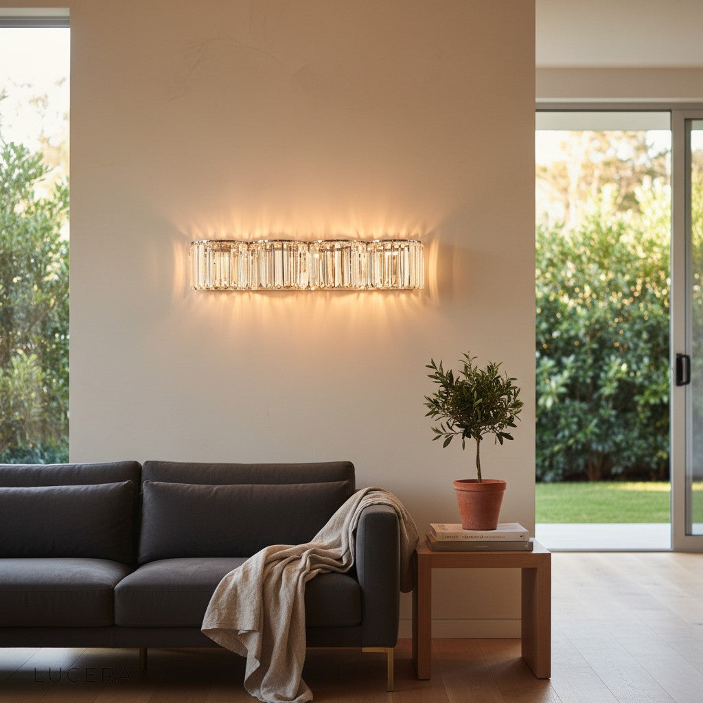 Silver Vibrato crystal sconce above a plush armchair in a reading nook with soft shadows