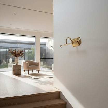antique brass LED wall light mounted on textured plaster wall in modern farmhouse room
