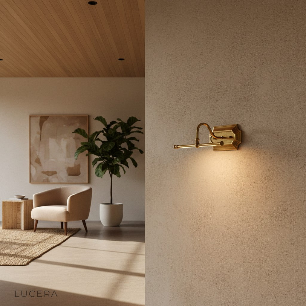 warm lit brass sconce beside a mirror in a chic vintage-inspired bathroom