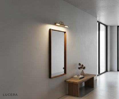 Nighttime shot of Ricochet Mirrored LED Lamp casting warm copper light against dark wall