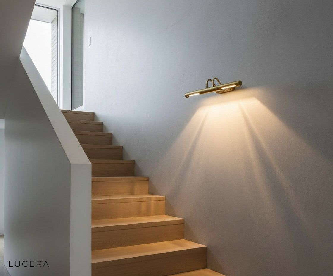 Ricochet Copper Wall Sconce in dining room with mirrored backplate reflecting candlelight and decor