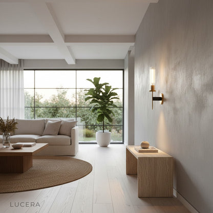 Aperta Palma wall light glowing at dusk in a serene bedroom setting