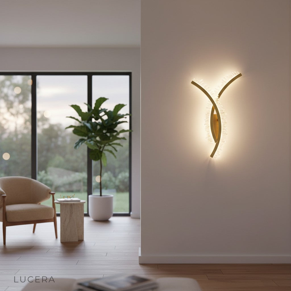 Voce LED sconce casting warm light over a chic bedroom nightstand and headboard
