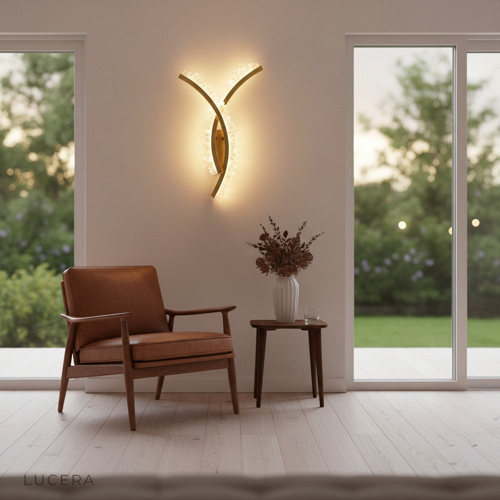 modern golden wall light mounted above minimalist console table in entryway