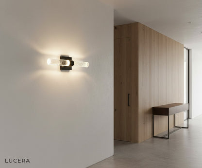 Mezza Bubble Crystal Wall Lamp styled above a bedside table in a chic hotel room