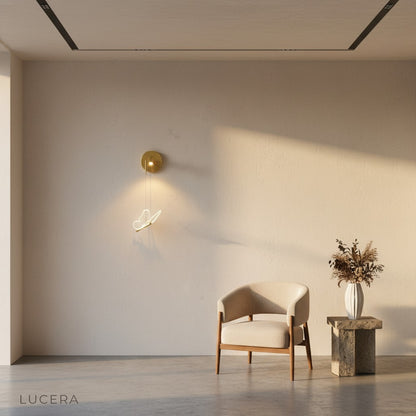 Piena butterfly lamp glowing in a cozy reading nook, warm light highlighting the metal and acrylic finish