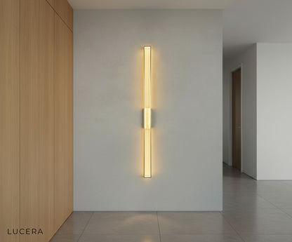 nighttime lifestyle shot of warm LED wall light casting cozy glow in a rustic hallway