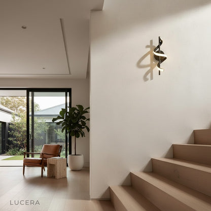 Crescendo modern LED wall sconce illuminated in dark hallway with soft accent glow