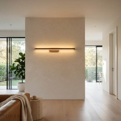 Sforzando LED wall fixture glowing elegantly in a contemporary dining room corner