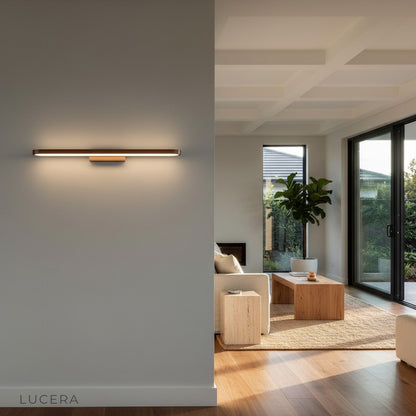 Sforzando brown LED light illuminating a dark accent wall with dramatic shadows