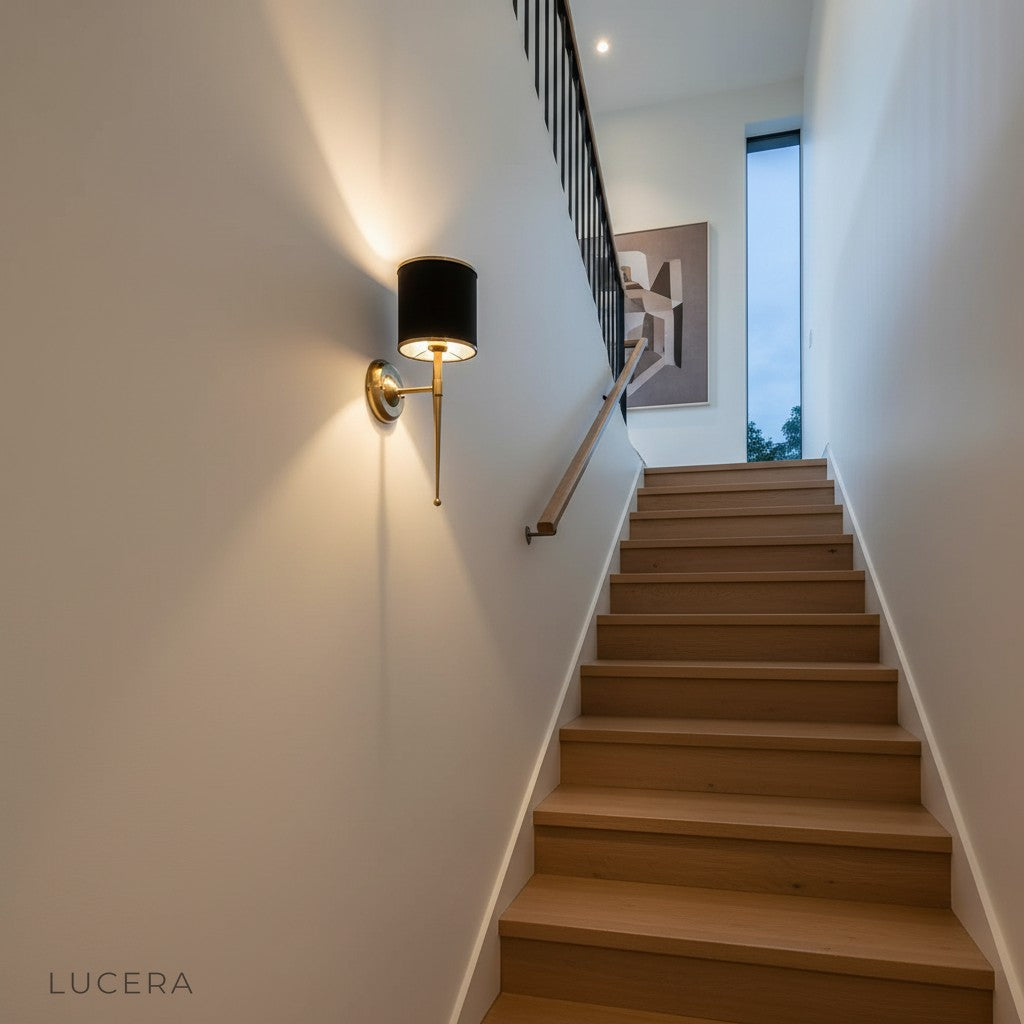 Morendo wall sconce illuminating hotel lobby wall with elegant fabric shade and metal base