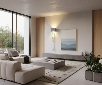 Rallentando copper crystal sconce illuminated at night in minimalist living room with warm tones