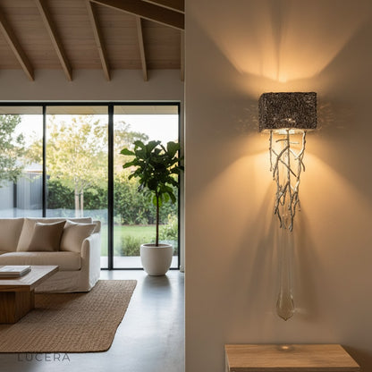 Rallentando LED crystal wall lamp above entryway console with copper finish and sparkling light