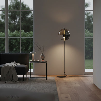 Oubliette Floor Lamp beside cozy armchair in warm neutral interior