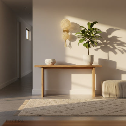 gold Sacro wall art lamp mounted above sofa in elegant lounge with soft evening lighting