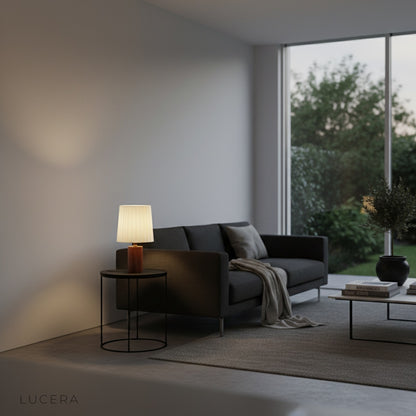 Pandora Table Lamp illuminated at dusk on console table with medieval-style decor and brass candlestick holder