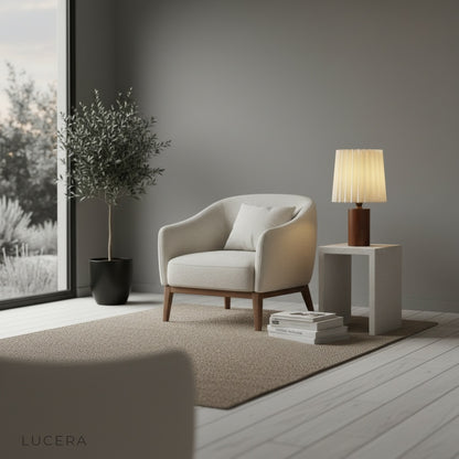 Pandora Table Lamp casting soft non-glaring light on dark wooden desk with vintage books and quill pen