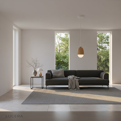 Holly pendant light glowing softly in an evening setting with dark moody interior