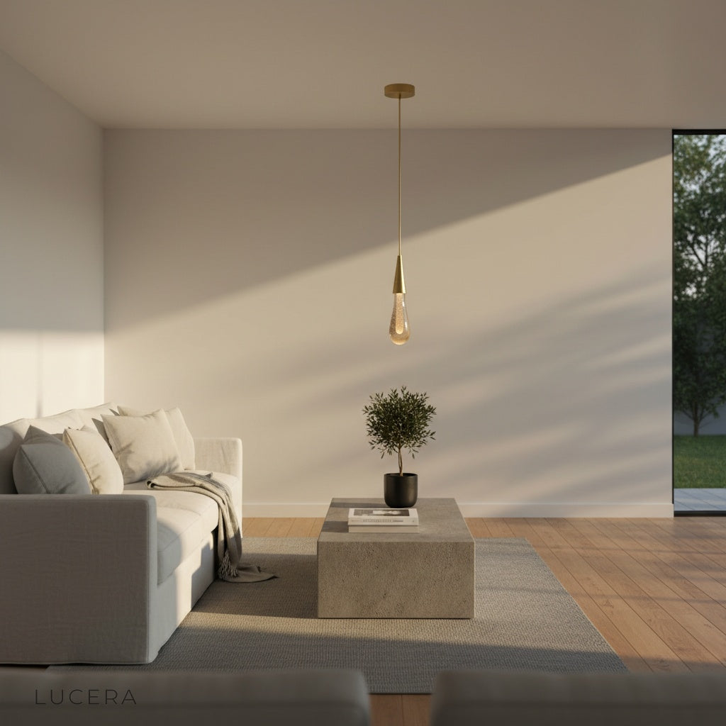 Beryl pendant light hanging above cozy reading nook with warm lamp glow