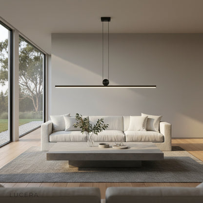 Eleonora pendant light hanging above kitchen island in contemporary open-plan space with warm ambient light