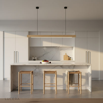 Kirsch pendant light in warm pine finish above a dining table, soft downward light