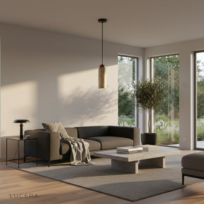 Minimalist studio view of Clandestine pendant light showing two distinct travertine shapes, front and side angles