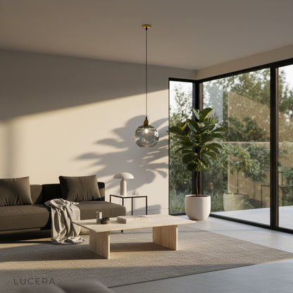 Kronos pendant light close-up of gold fitting and textured glass surface detail