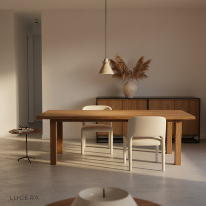 Minimalist studio view of Jazzle pendant light at 45-degree angle highlighting smooth travertine surface and warm wood accent