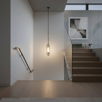 evening lifestyle shot of Lucera pendant lamp above minimalist bedside table in bedroom