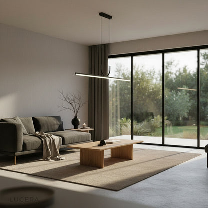 Black Honeysuckle linear pendant light over a dining table with warm ambient glow in an evening setting