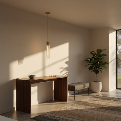 Hester Pendant Light in iron finish hanging over a kitchen island with stools