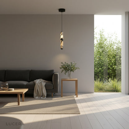 sculptural marble pendant light hanging over a kitchen island with soft ambient shadows