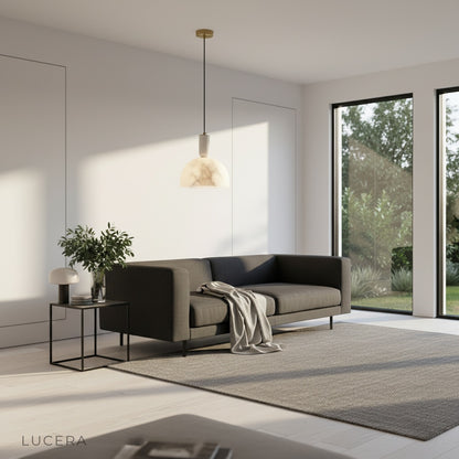 Midas pendant light illuminated at dusk casting warm ambient glow in cozy bedroom corner