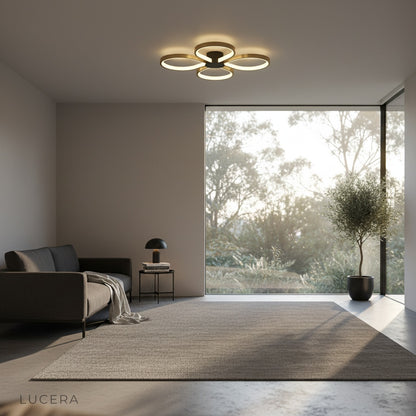 close-up view of the four circular LED rings and brushed brass finish of the ceiling light