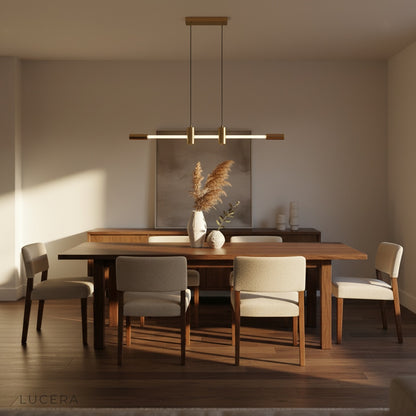 Gideon pendant light hanging over a cozy reading nook with soft ambient lighting