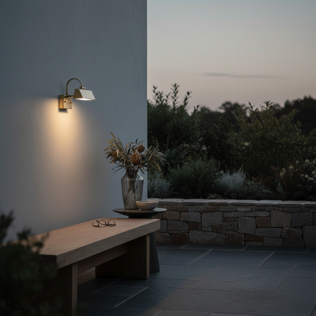 Quiete wall light on a stone wall beside a modern outdoor sofa