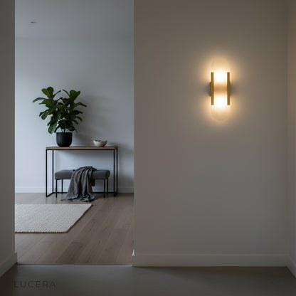 Nettle wall lamp in matte black finish mounted above a minimalist console table in hallway