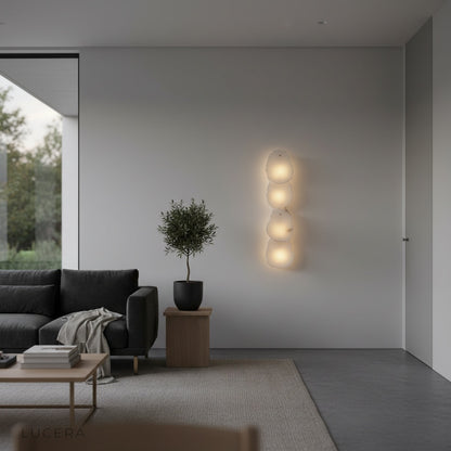Esker wall lamp in a hallway with soft evening glow and marble accents