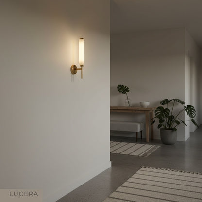 Boreas wall lamp with alabaster shade glowing at dusk in minimalist living room corner