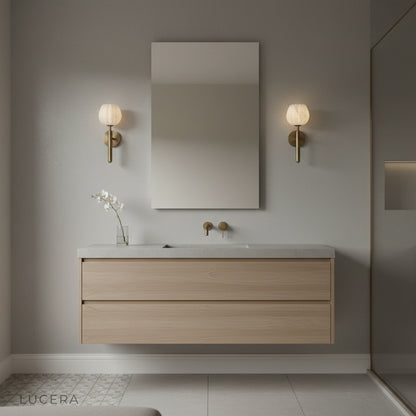 alabaster wall lamp illuminating a dark hallway with soft, honey-toned light at night