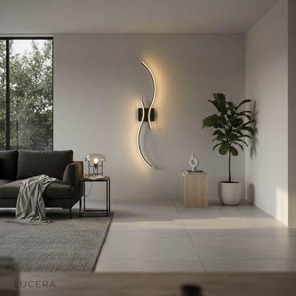 Ulric wall lamp glowing softly in minimalist bedroom with warm ambient light