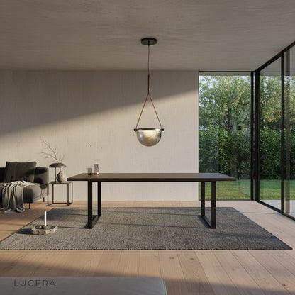 Glimmer pendant light casting warm light in a stylish hotel model room