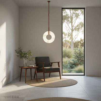 Helix alabaster pendant light hanging over kitchen island with soft daylight and neutral decor