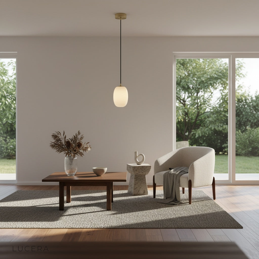 Minimalist studio view of Lucera Embellish pendant light showing natural alabaster texture and black cord