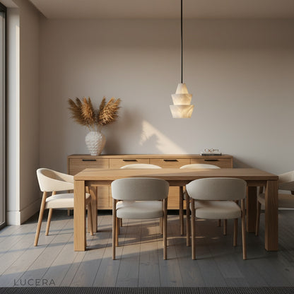 Elegant Fillet Alabaster pendant light illuminating cozy reading nook with linen armchair